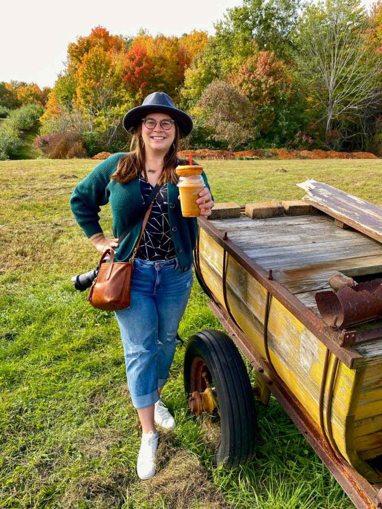 Amanda with an apple cider slushie outdoors